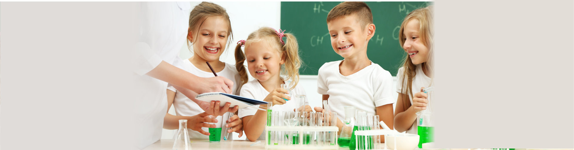 Cute pupils with teacher doing biochemistry research in chemistry class